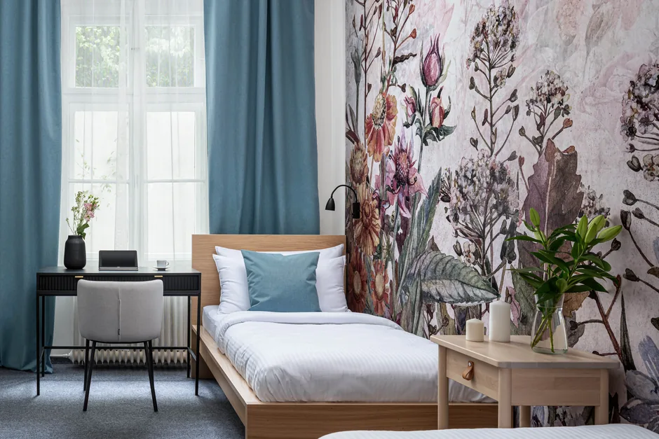 Po rekonstrukci: pokoj do dvora v hotelu Botanica s tapetou a dvěma lůžky, září 2025